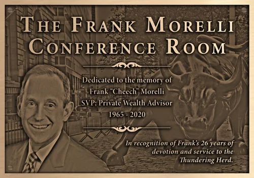 Bronze Frank Morelli Conference Room dedication plaque with an engraved portrait and a Wall Street charging bull background.