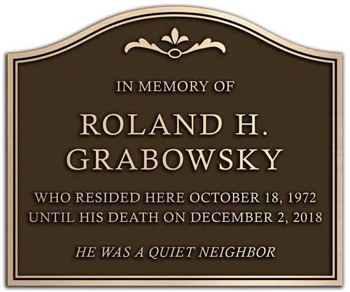 A special shaped bronze memorial dedication plaque.