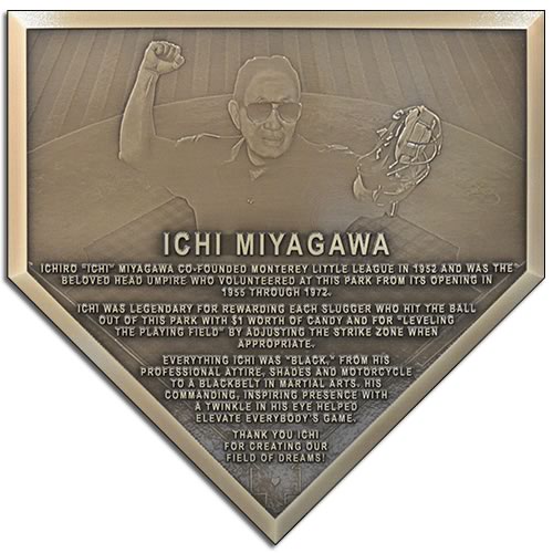 A memorial plaque in the shape of a baseball home plate used to honor the memory of a baseball Umpire.