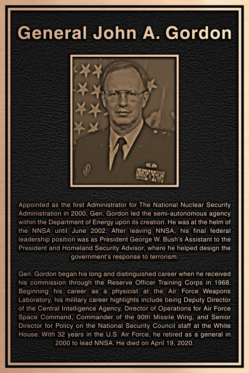 Bronze tribute plaque with portrait relief and service biography