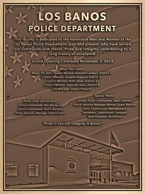 A bronze dedication plaque for a newly built police station.
