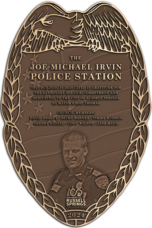 A bronze plaque featuring a police badge in raised relief.