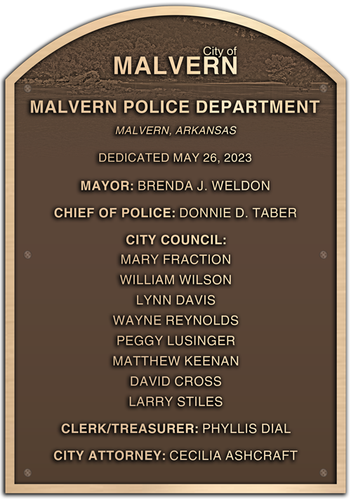 A bronze dedication plaque for a public safety building.